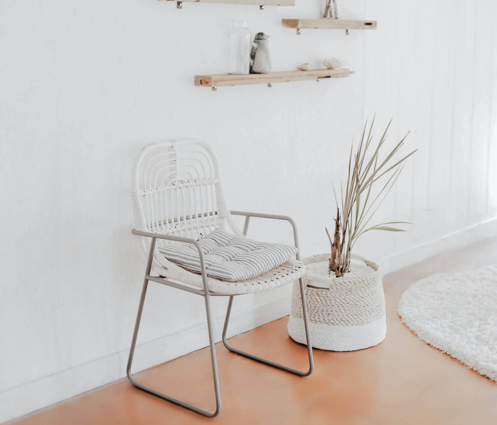 white chair next to potted plant